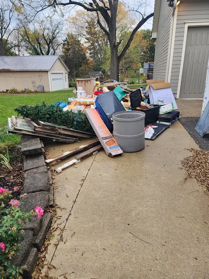 Dumpster being loaded with debris for Roofing Dumpster Rental in Amity